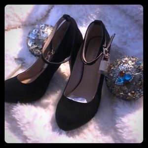 Black suede heels, size 7 with ankle straps.